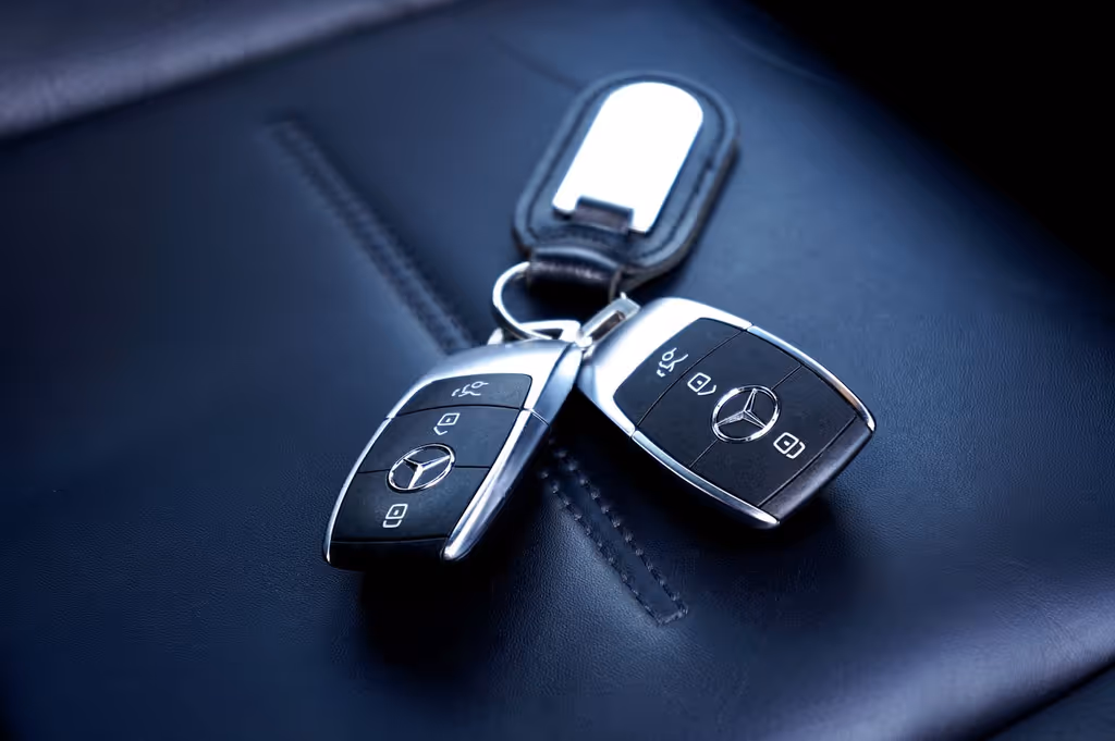 Keys resting on the leather seat of a premium car interior